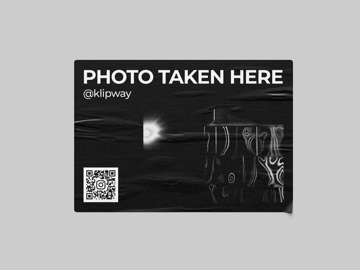 A sticker reading Photo Taken Here with a QR code, placed at the spot the photograph was made.