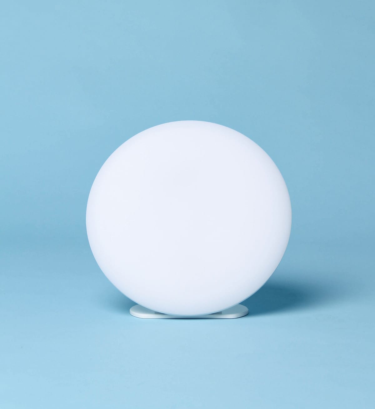 The lamp alone on a pale blue backdrop.